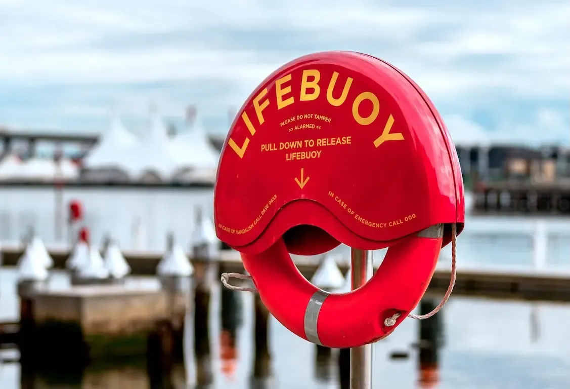 Emergency life-saving equipment mounted on pole.