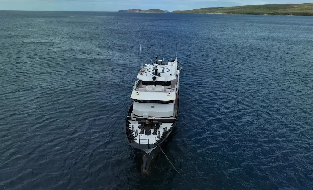 A commercial vessel travelling on open water.