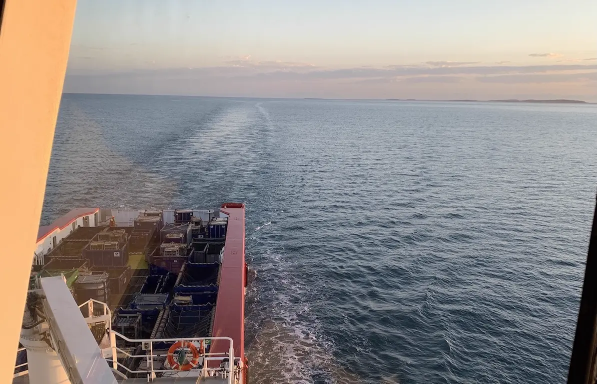 Crew members standing together on a boat deck.