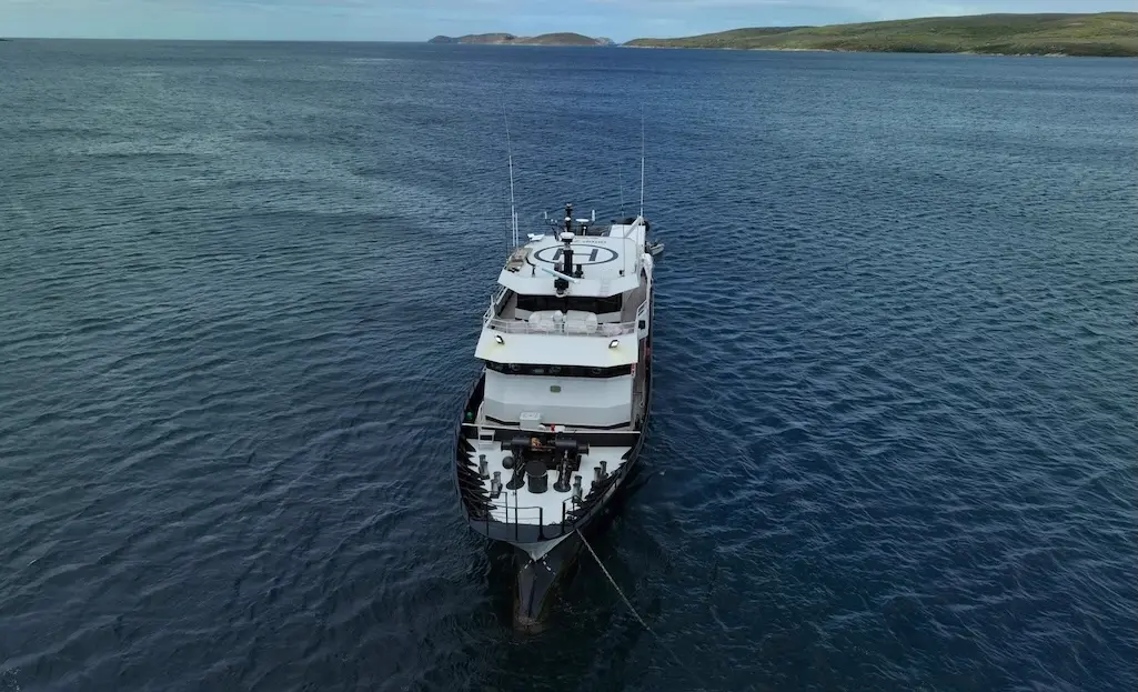 A commercial vessel travelling on open water.