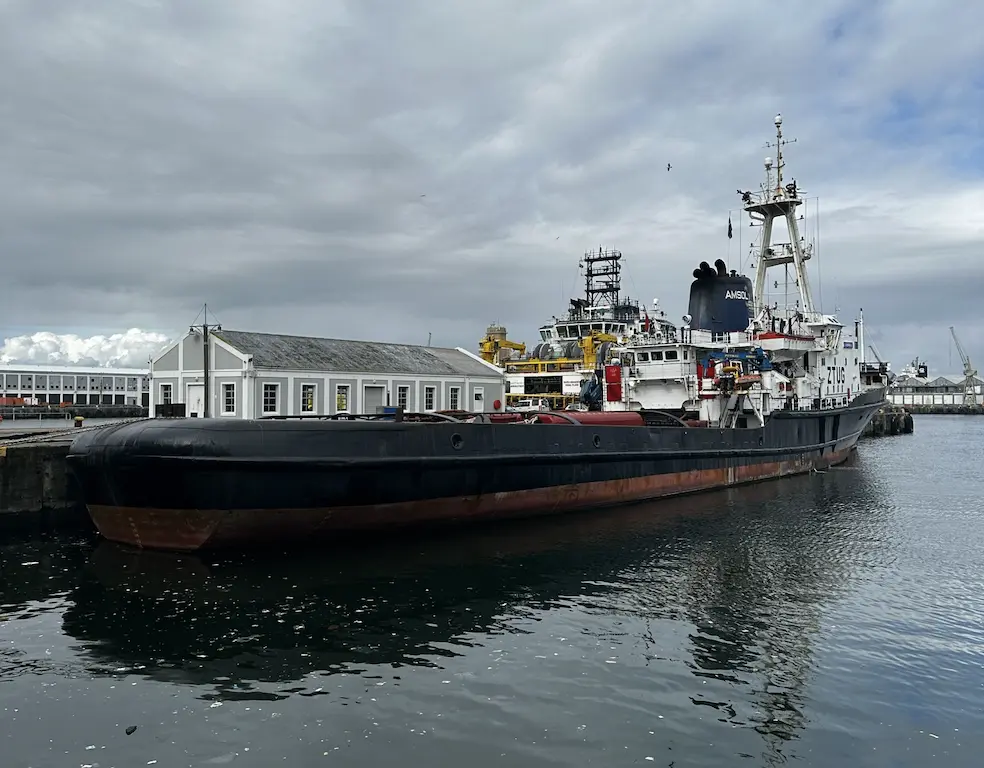 A tug vessel docked at a port.